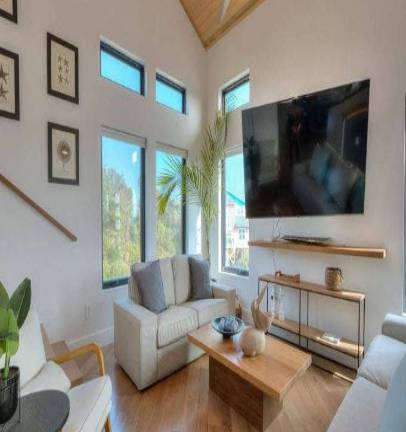 pristine Island Beach, relaxing expression, inviting sunbathers, photorealistic, turquoise waters meeting white sand, highly detailed, seagulls in flight, perfect symmetry, vibrant blues, bright sunlight, shot with a wide-angle lens.