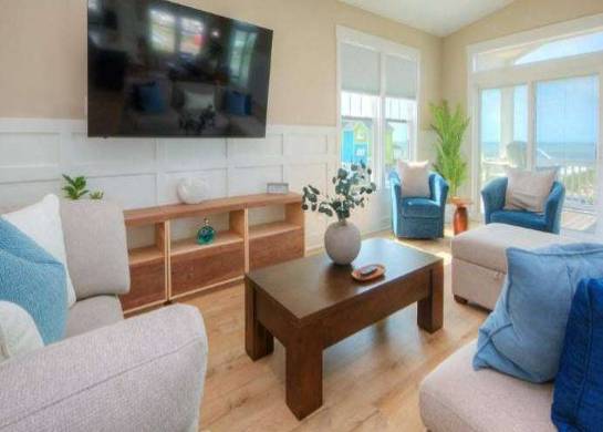 breathtaking oceanfront sunset, awe-inspiring beauty, casting long shadows, photorealistic, panoramic view of the ocean meeting the horizon, highly detailed, vibrant clouds with pink and orange hues, ISO 100, soft twilight glow, low-light evening setting, shot with a 50mm prime lens.